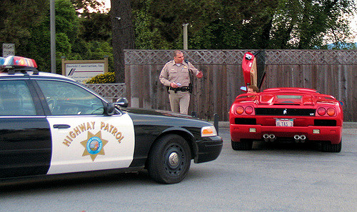 Policeman Giving A Traffic Ticket To A Ferrari Cop Pulling Over A Nice Red Car